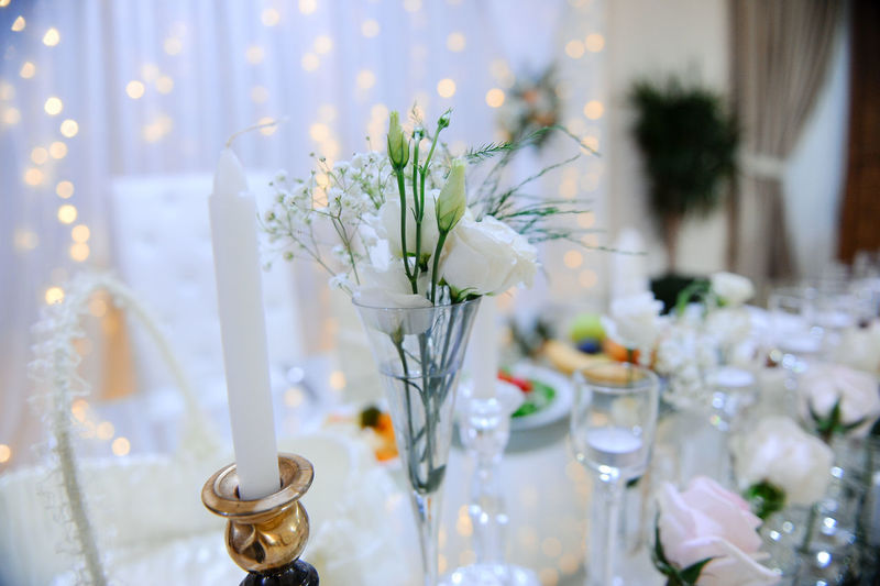 White flowers in glass vase on table