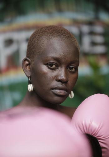 Close-up portrait of woman with boxing gloves
