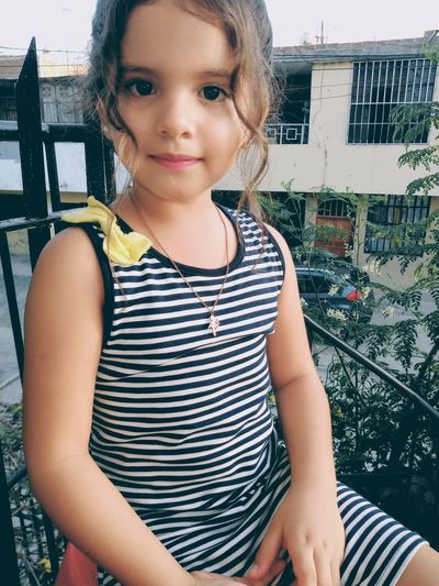 Portrait of girl sitting in balcony
