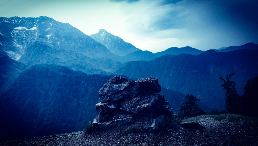 Scenic view of rocks and mountains against sky