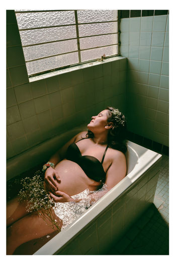 High angle view of pregnant woman in bathtub at home