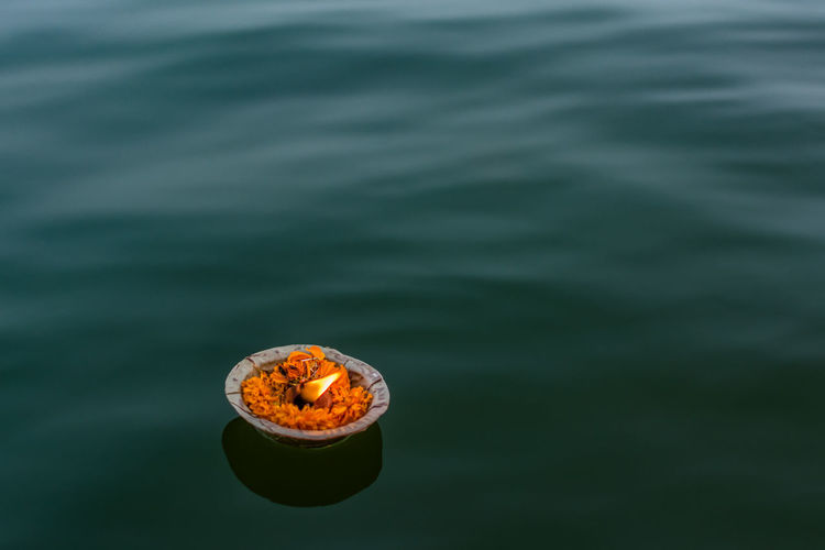 Close-up of burning floating on water