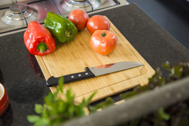 High angle view of vegetable with knife on cutting board