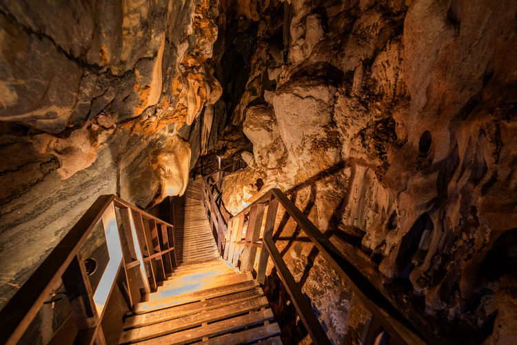 The wooden walking path through stalactite and stalagmite in phu pha petch cave at thailand