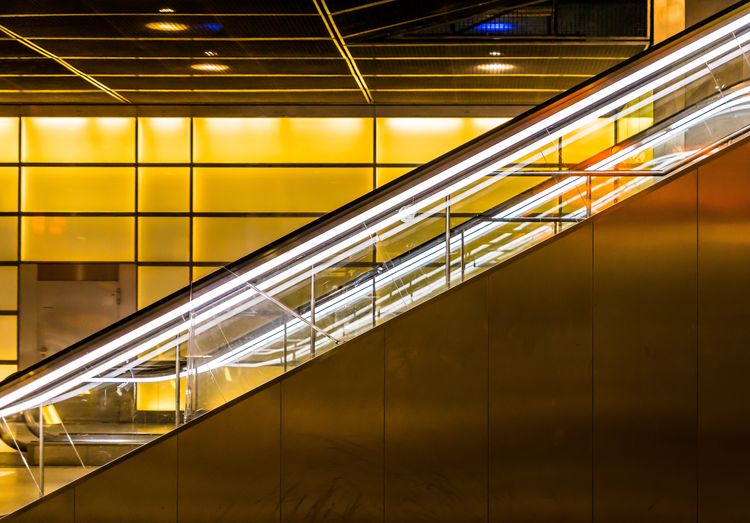 Illuminated railings of escalators at subway station