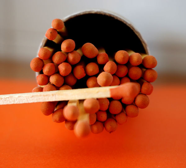 Close-up of berries on table against orange background