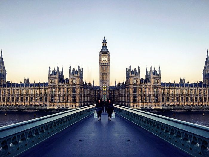People walking on westminster bridge against clear sky