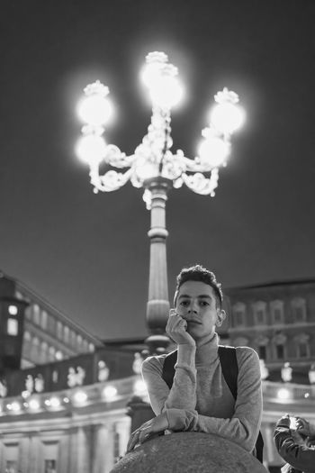 Portrait of woman with illuminated lights at night