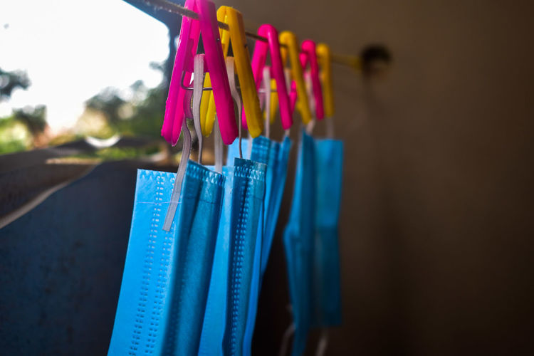 Close-up of face masks hanging on clothesline