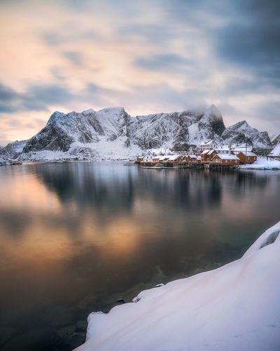 Scenic view of lake against sky during winter
