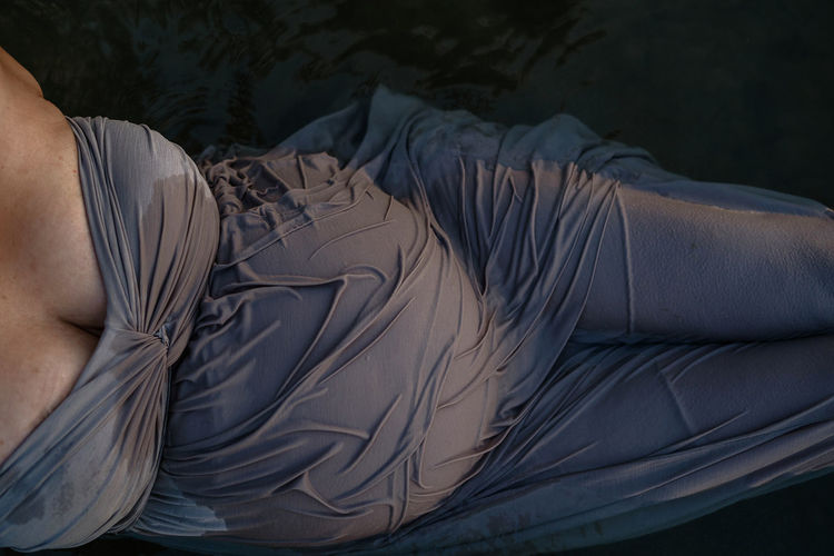 High angle view of pregnant woman lying in lake water