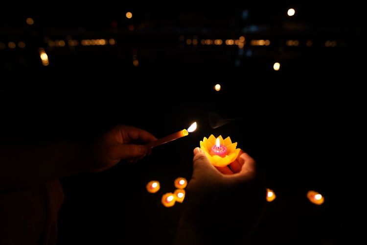 Person holding lit candles