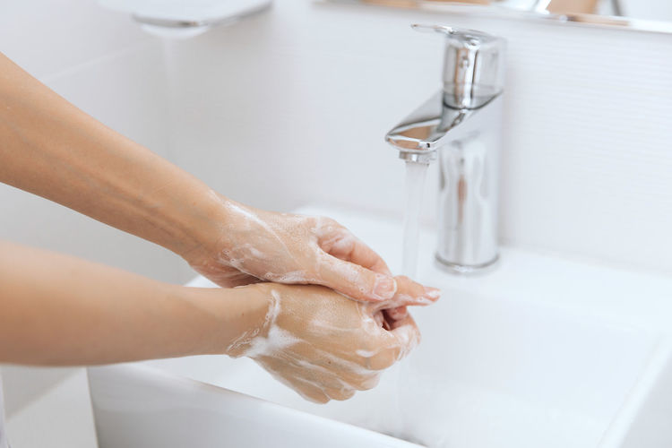 Cropped image of woman washing hands