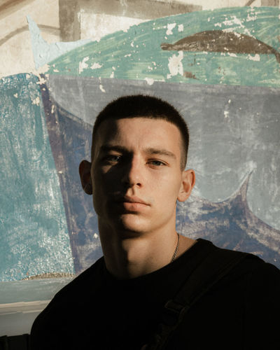 Portrait of young man against wall