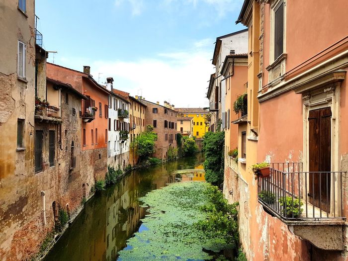 Canal amidst buildings in mantova 