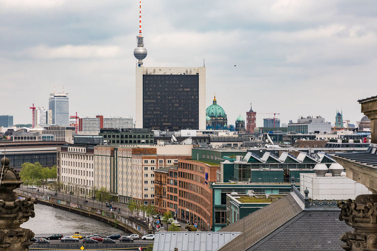 Modern buildings in german capital berlin with river spree against sky