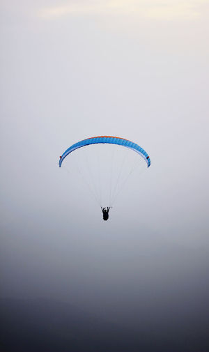 Man paragliding against clear sky