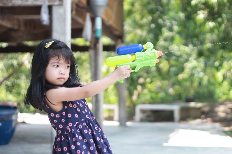 Girl playing with squirt gun