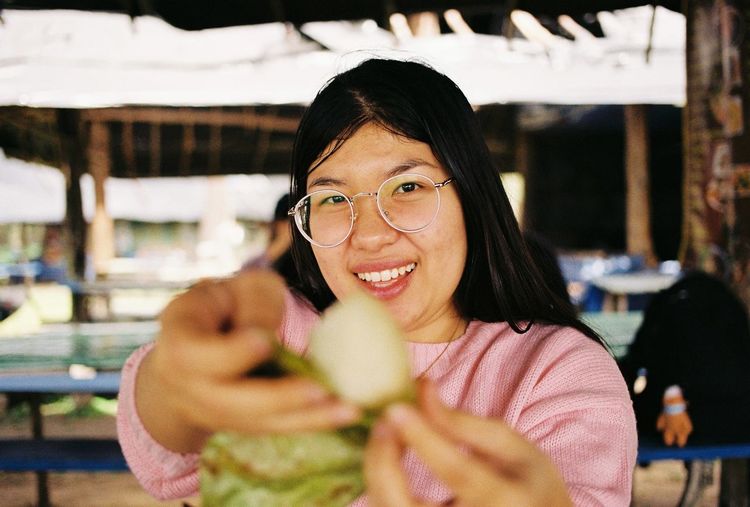 Portrait of young woman holding apple