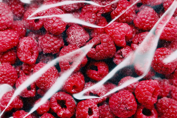 Full frame shot of raspberries in plastic