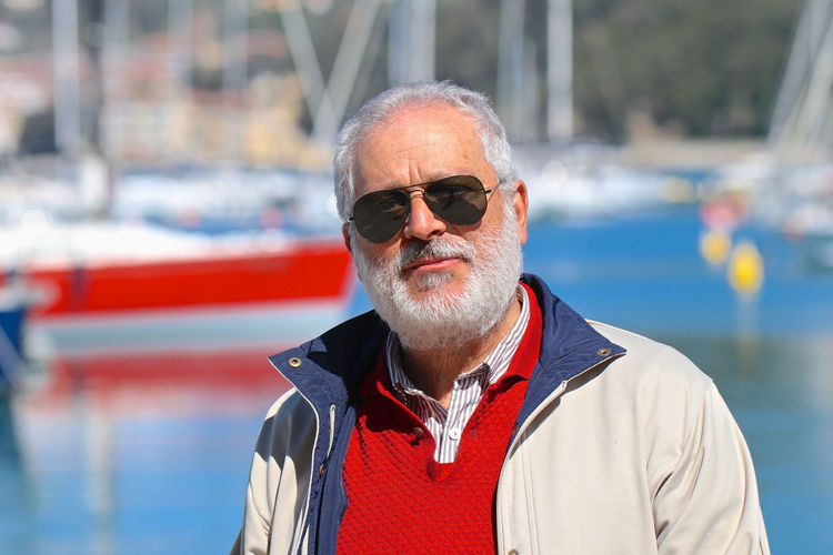 Portrait of man wearing sunglasses by sea