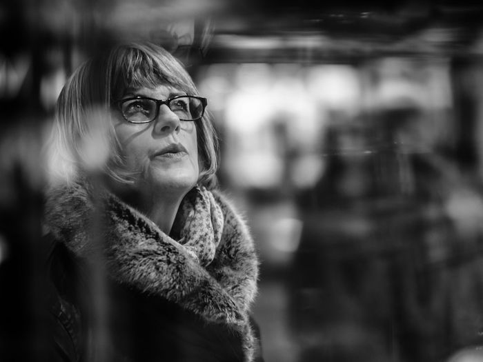 Thoughtful mature woman wearing scarf looking up during winter