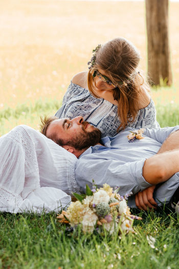 Young couple kissing on grass