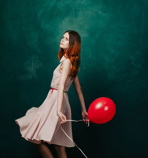 Side view of woman with balloons
