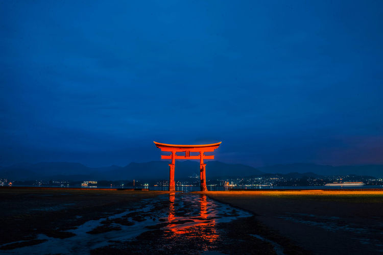 Itsukushima shrine in sea at dusk