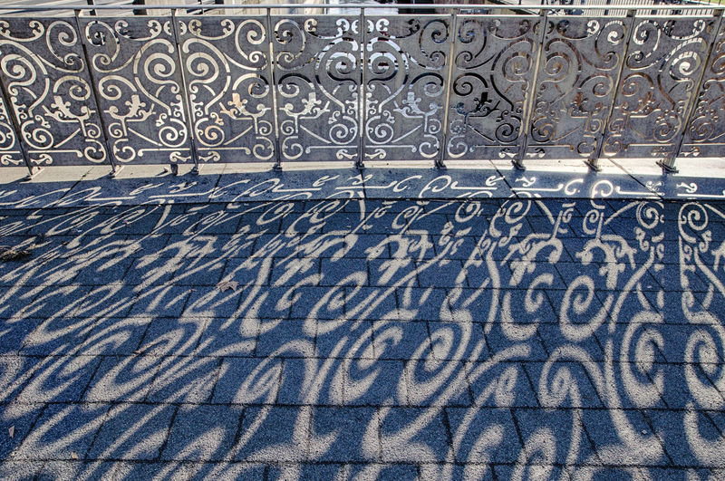 High angle view of shadow pattern on footpath