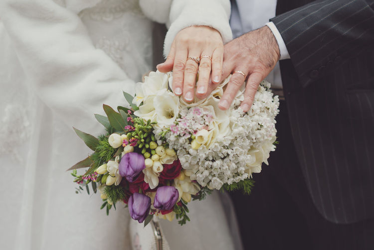 Close-up of hand holding flower bouquet