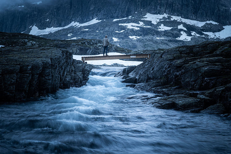 Scenic view of frozen river amidst snowcapped mountains