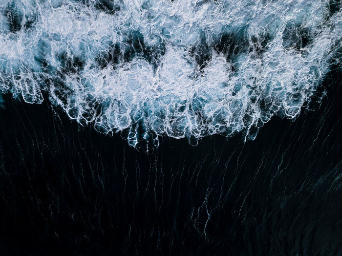 Close-up of frozen sea against black background
