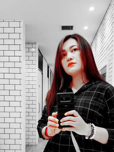 Portrait of young woman using mobile phone