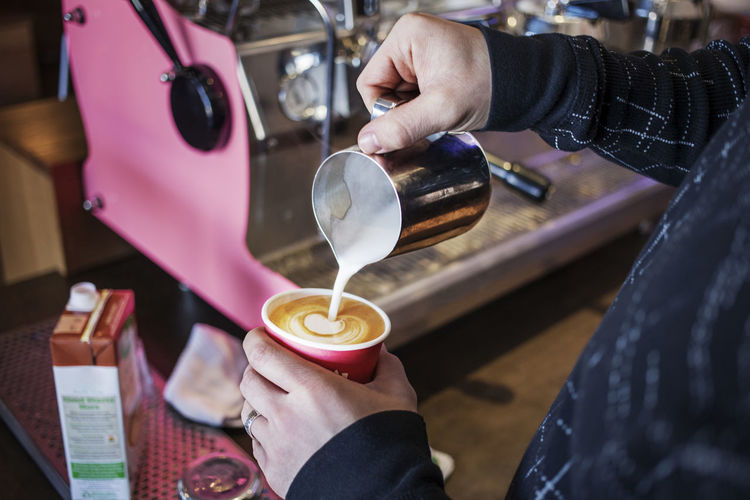 Cropped image of woman making coffee