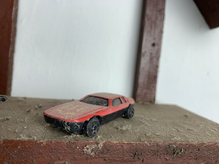 Close-up of toy car on table against wall
