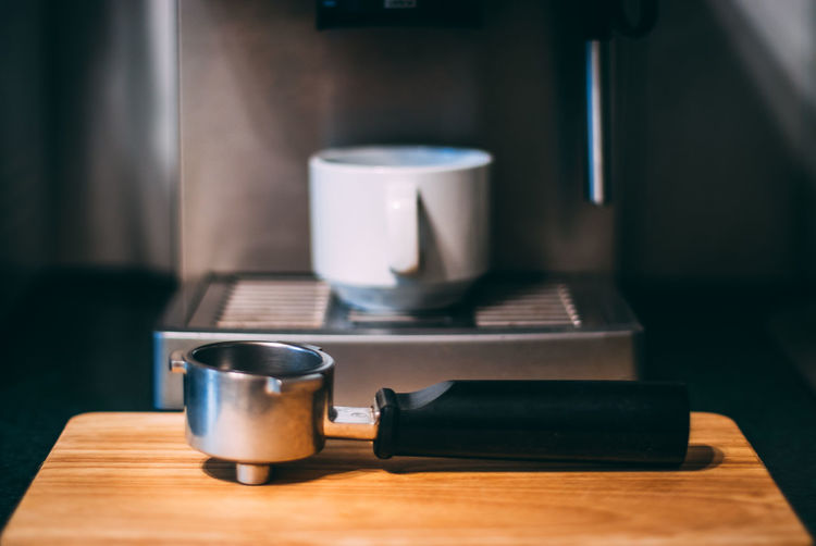 Close-up of coffee cup on table at home