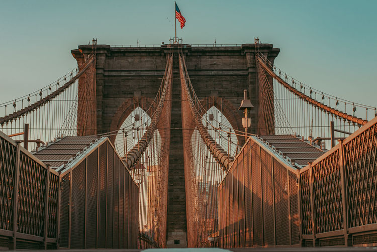 Low angle view of suspension bridge against sky
