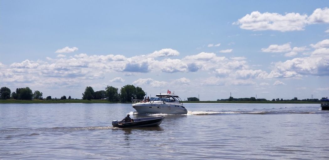 Boat sailing in sea against sky