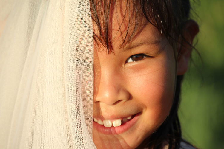 Close-up portrait of cute girl wearing veil