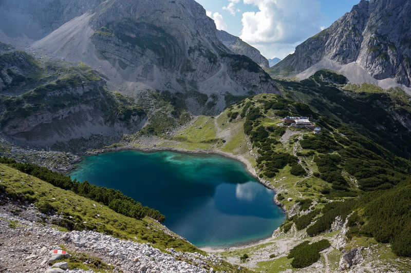 Scenic view of river amidst mountains against sky