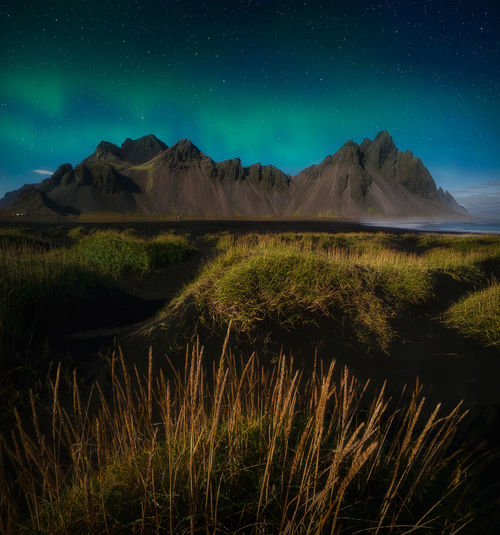 Scenic view of landscape against sky at night