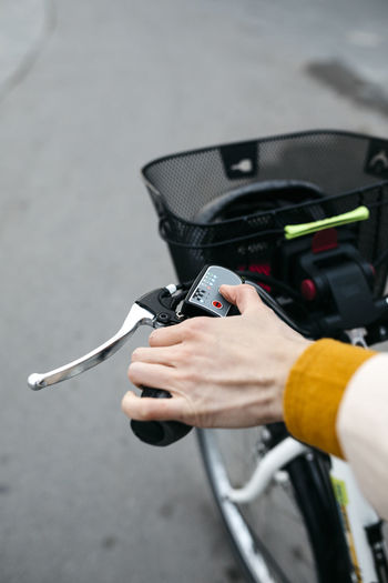 Close-up of woman on e-bike connecting the electric motor