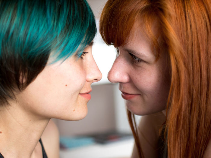Close-up of lesbian couple romancing at home
