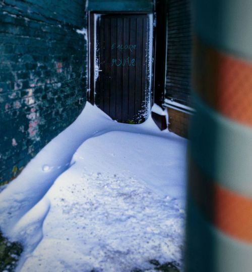 Close-up of snow by escape door