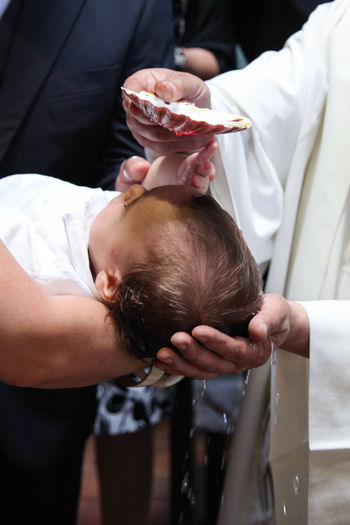 Midsection of priest with family in church