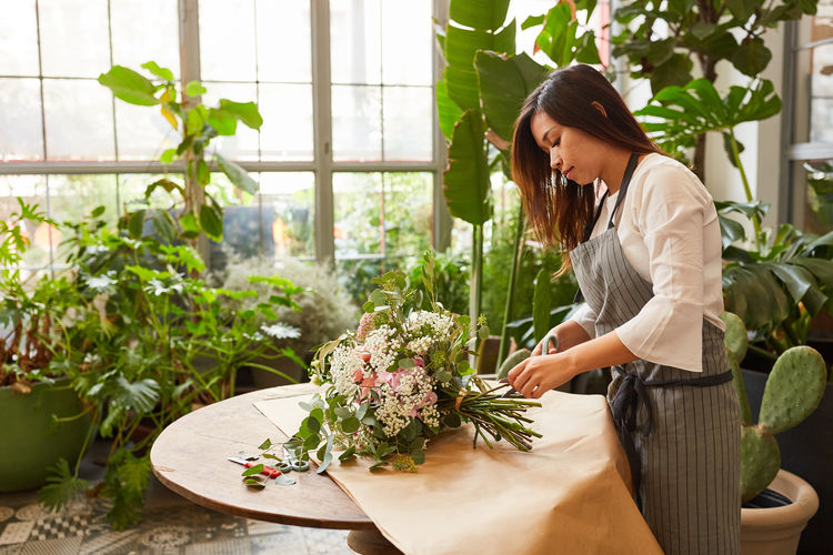 Woman looking at potted plants