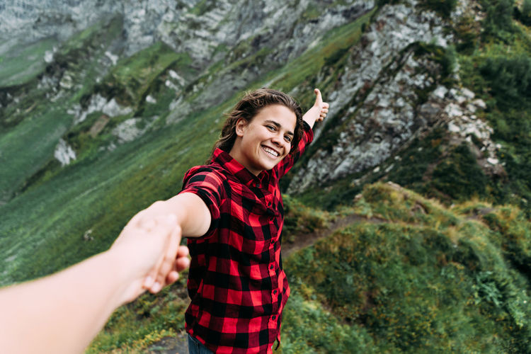 Portrait of young woman standing on mountain