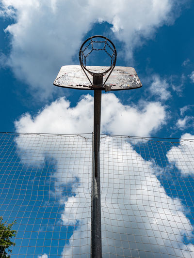 Basketball and a basket in an outdoor court with natural sun lightning.