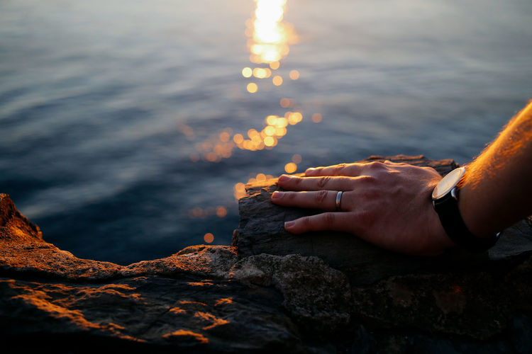Male hand against sea